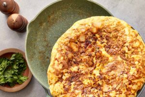 Flipped tortilla española on plate after turning