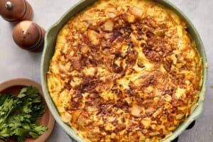 Flipped tortilla española on plate after turning
