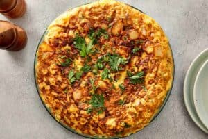 Finished tortilla española garnished with parsley
