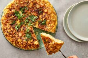 Slice of tortilla española being served