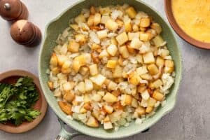 Potatoes and onions cooking together until soft