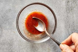 lime juice and spices mixed in a bowl to start tuna salad dressing