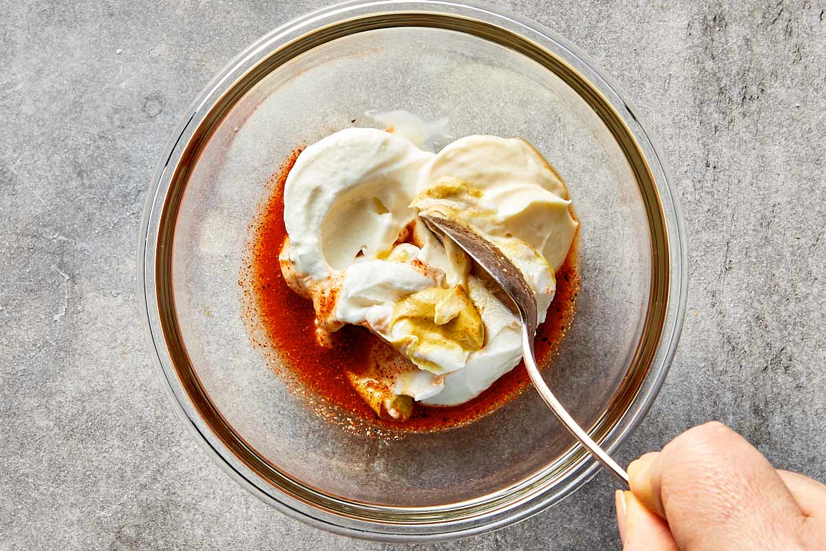 adding mayonnaise sour cream and dijon mustard to tuna salad dressing