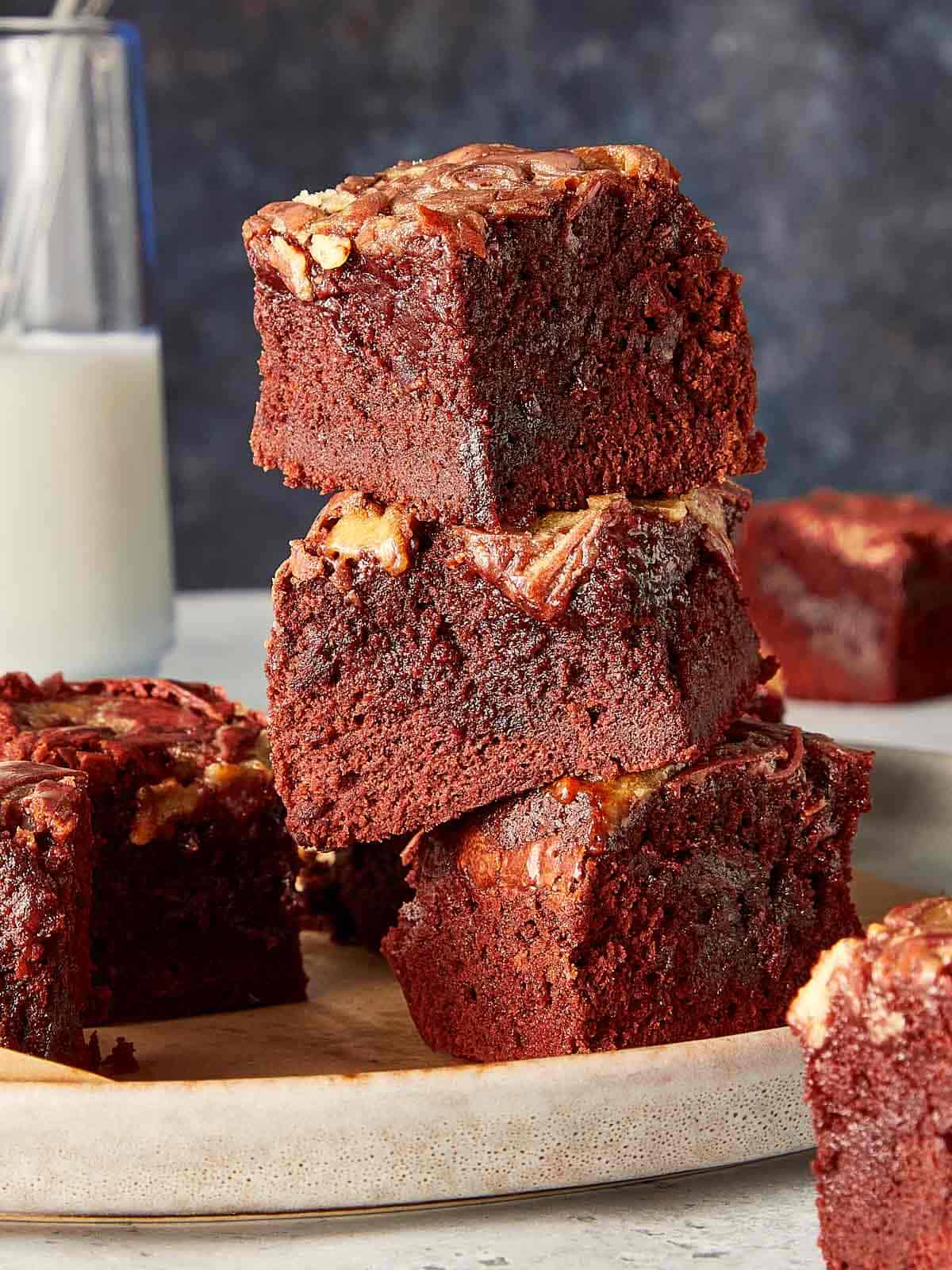 Close up of a view of three pieces of Red Velvet Brownies stacked in a elegant background