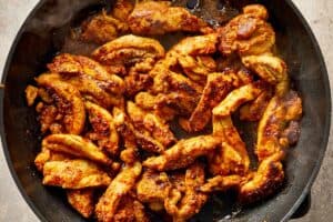 Chicken being cooked in a skillet