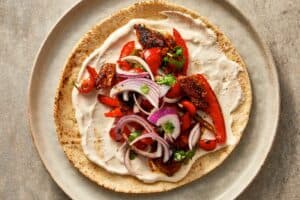 Tortilla with tahini sauce, veggies and chicken