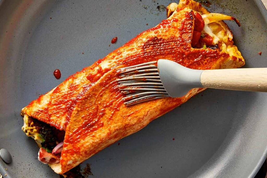 brushing shawarma glaze before cooking