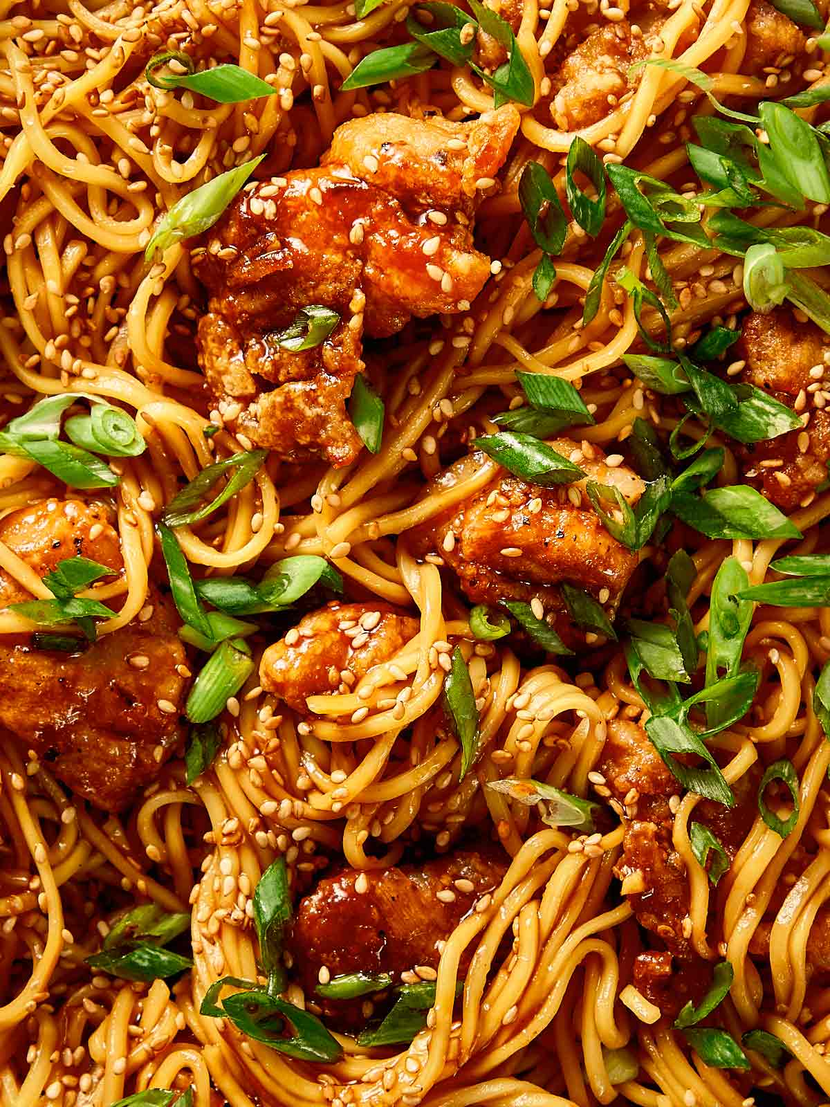 Close-up of honey sesame chicken noodles
