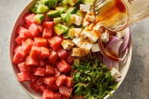 pouring the dressing in the salad