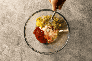 Mixing Ingredients for the Burger Sauce in a glass bowl