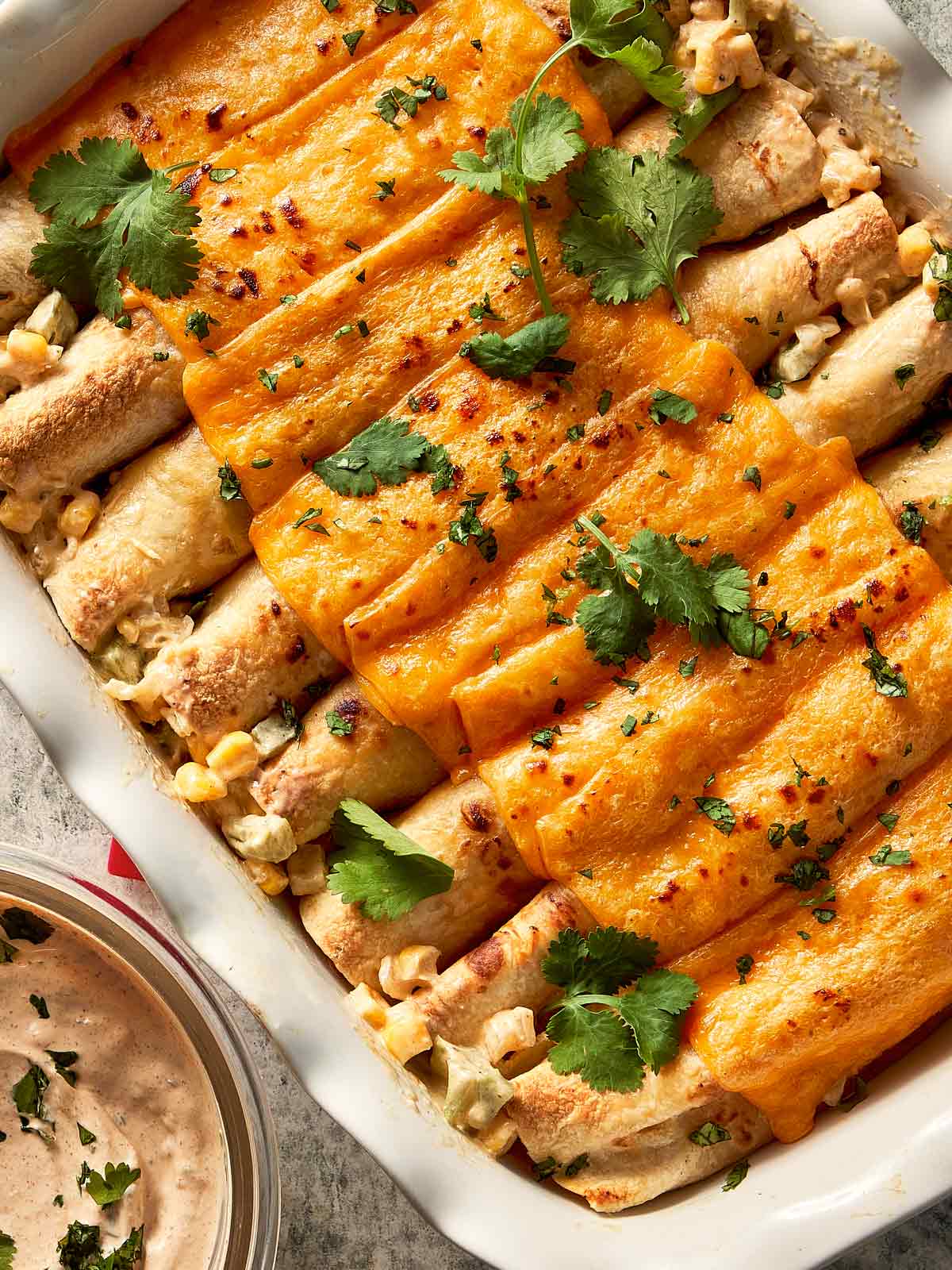 chicken burritos with cheddar cheese at the top