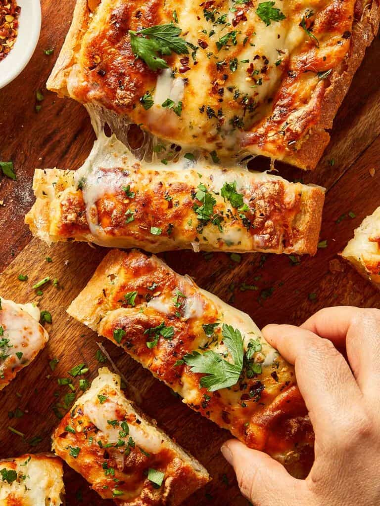 Pulling a piece of garlic bread