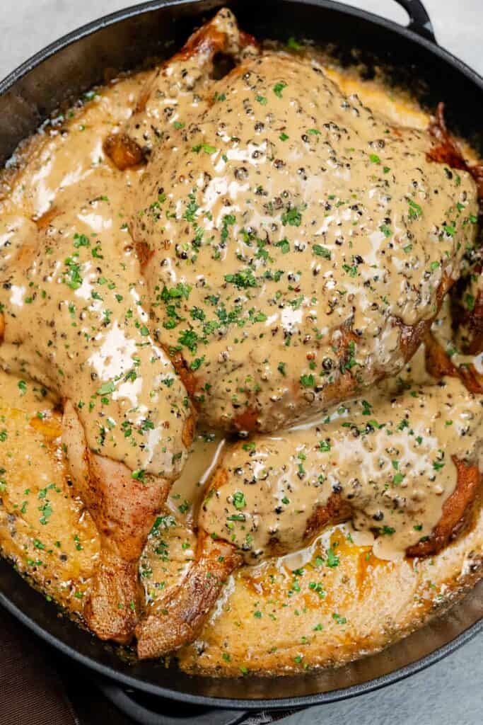 close-up chicken au poivre covered with cream and garnished