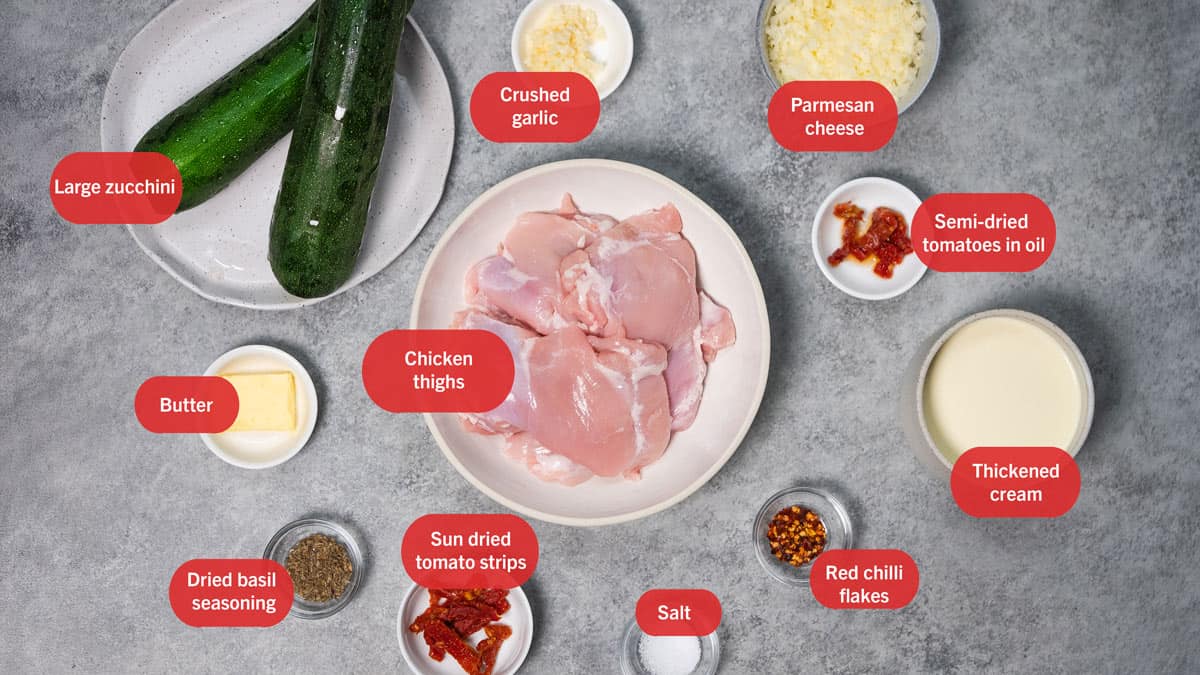 Top view of ingredients in plates for chicken zucchini spaghetti