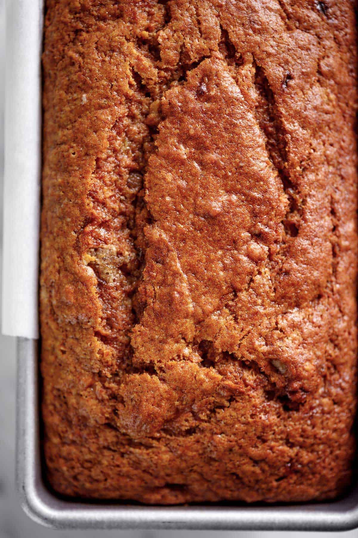 A loaf of moist banana bread baked in a loaf tin